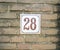 House Number 28 twenty eight. brown numbers on a white plate con