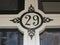 house number 29 painted in black on a woorden front door