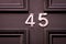 House number 45 on a black wooden front door