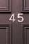 House number 45 on a black wooden front door