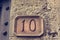 House number carved into clay tablet on facade.