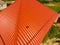 House with an orange roof of metal, top view. Metallic profile painted corrugated on the roof