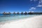 House over the water of a blue tropical sea with a thatched roof in a typical authentic Polynesian style