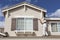 House Painter Painting the Trim And Shutters of Home