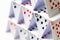 House of playing cards over white background