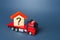 House with a question mark on a truck. House moving and relocation. Solving housing problems, buy real estate. Search for new