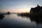 House reflected on the Hemmelsdorfer See lake against a beautiful surise