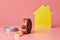House renovation funny concept. Metal tape measure and other repair items. Home repair and redecorated concept. Yellow house