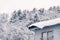 House roof blanketed in a layer of snow outside in a wintery landscape. Otaru, Hokkaido, Japan.