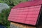 House with a roof made of solid metal sheets, shaped like an old til