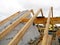 House roof top wooden frame construction. Unfinished house roofing construction wooden beams, trusses, timber