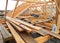 House roofing construction panorama. Installing wooden rafters, eaves, waterproofing logs with bitumen