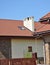 House rooftop with attic skylight window, roof gutter,  and dirty chimney