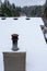 House rooftop covered in snow, rusty chimney vent, roof vents, wood siding