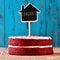 House-shaped chalkboard with the text congrats in a cake, with a