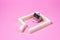 House-shaped tea strainer on a pink background. Tea strainer with sugar cubes. Refined sugar. Small house. Brewing tea.