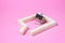 House-shaped tea strainer on a pink background. Tea strainer with sugar cubes. Refined sugar. Small house. Brewing tea.