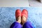 House slipper shoe in living room with blue carpet