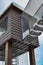 a house on stilts in a childrens park with a suspended walkway