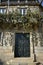 House with stone vine tree. Balcony with iron handrail and vine tree. Santiago de Compostela, Spain.