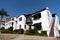 House in suburb. Private residence surrounded by picket fence. Suburban architecture