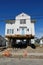 House on supports as it is being raised to protect it from raising flood waters due to global warming