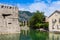 House with tile roof, canal and fortress wall in city of Kotor, in Montenegro
