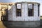 House under construction, walls of white foam aerated concrete blocks, wooden scaffolding, big window openings and concrete