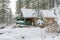 House under snow in winter wood chalet among spruce trees in the