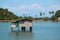 House on the water and green island in the Gulf of Siam, Thailand