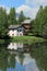 House and white lake at Crans Montana, by summer