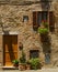A house with window and door with flowers of Pienza, Italy