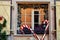 House window with metal shutters and heathers pots decorated for Christmas