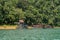 Houseboat crusing through the lake with mountain view at Kenyir Lake.