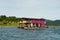Houseboat crusing through the lake with mountain view at Kenyir Lake. Tasik Kenyir is a man made