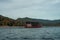 Houseboat crusing through the lake with mountain view at Kenyir Lake. Tasik Kenyir is a man made lake