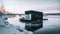 A houseboat floating on top of a frozen lake. AI generative image. Tiny house, houseboat.