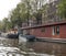 Houseboat moored at the side of an urban canal quayside