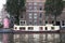 Houseboat moored at the side of an urban canal quayside