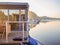 Houseboat on a river in a early sunny morning. floating house is a pleasant place for rent for weekend