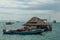 Houseboat and small boats near the ocean