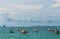 houseboat and small boats near the ocean without passengers on a warm sunny day