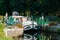 Houseboats with tourists pass through river locks on the river Oust near Josselin in Brittany