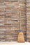 Household Broom For Floor Cleaning Leaning on Brick Wall