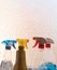 Household cleaning products in spray bottles next to a window -red, blue, yellow, chemicals, clean, copy space