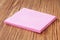 Household concept. Pink micro fiber napkins on wooden background