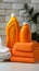 Household freshness Orange liquid washing powder bottle beside neatly folded towels