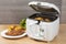 Household kitchen - A white automatic electric fryer pot