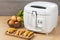 Household kitchen - A white automatic electric fryer pot
