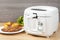 Household kitchen - A white automatic electric fryer pot